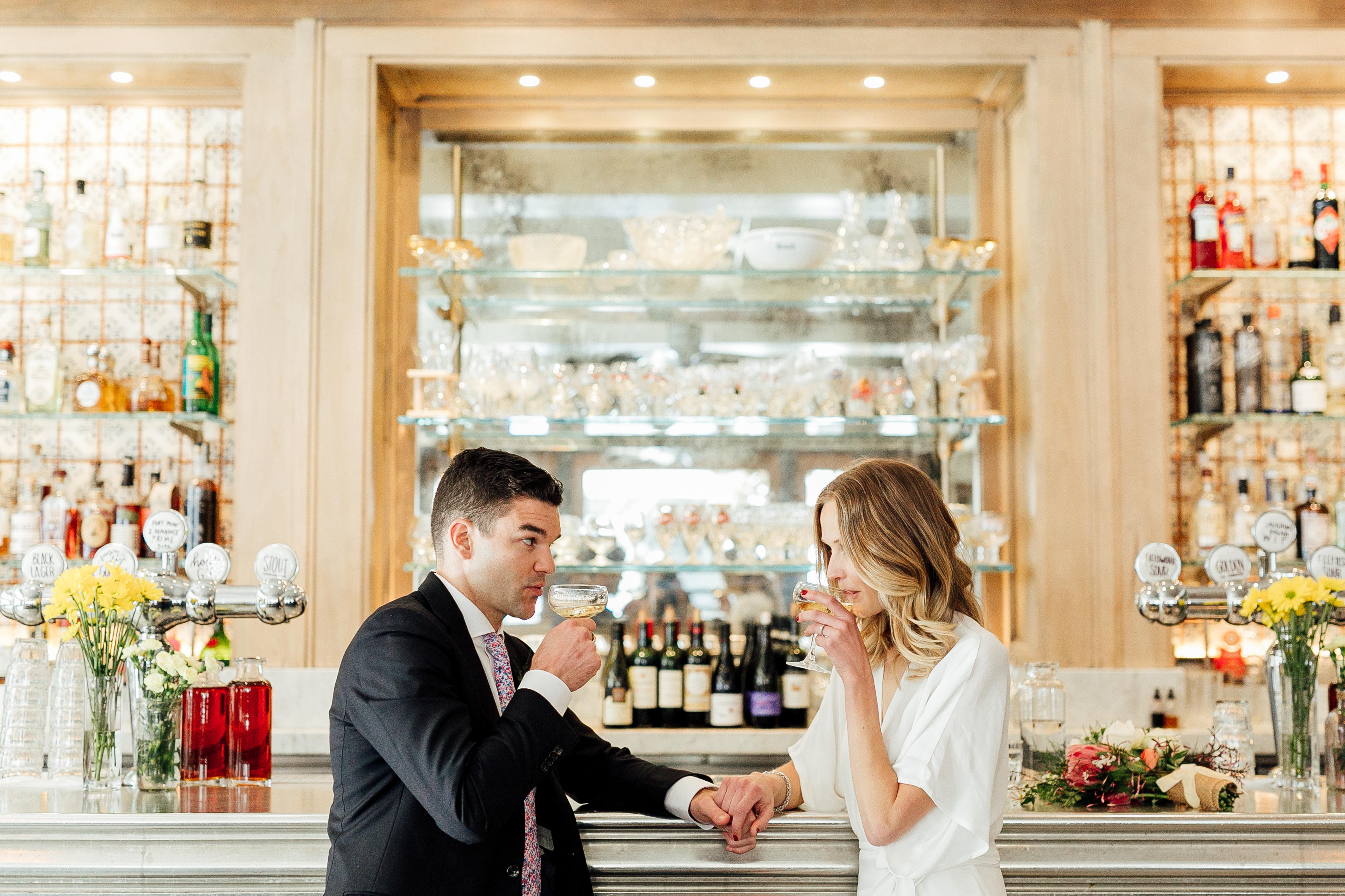 ethically dressed bride and her husband on their wedding day with champagne in San Francisco