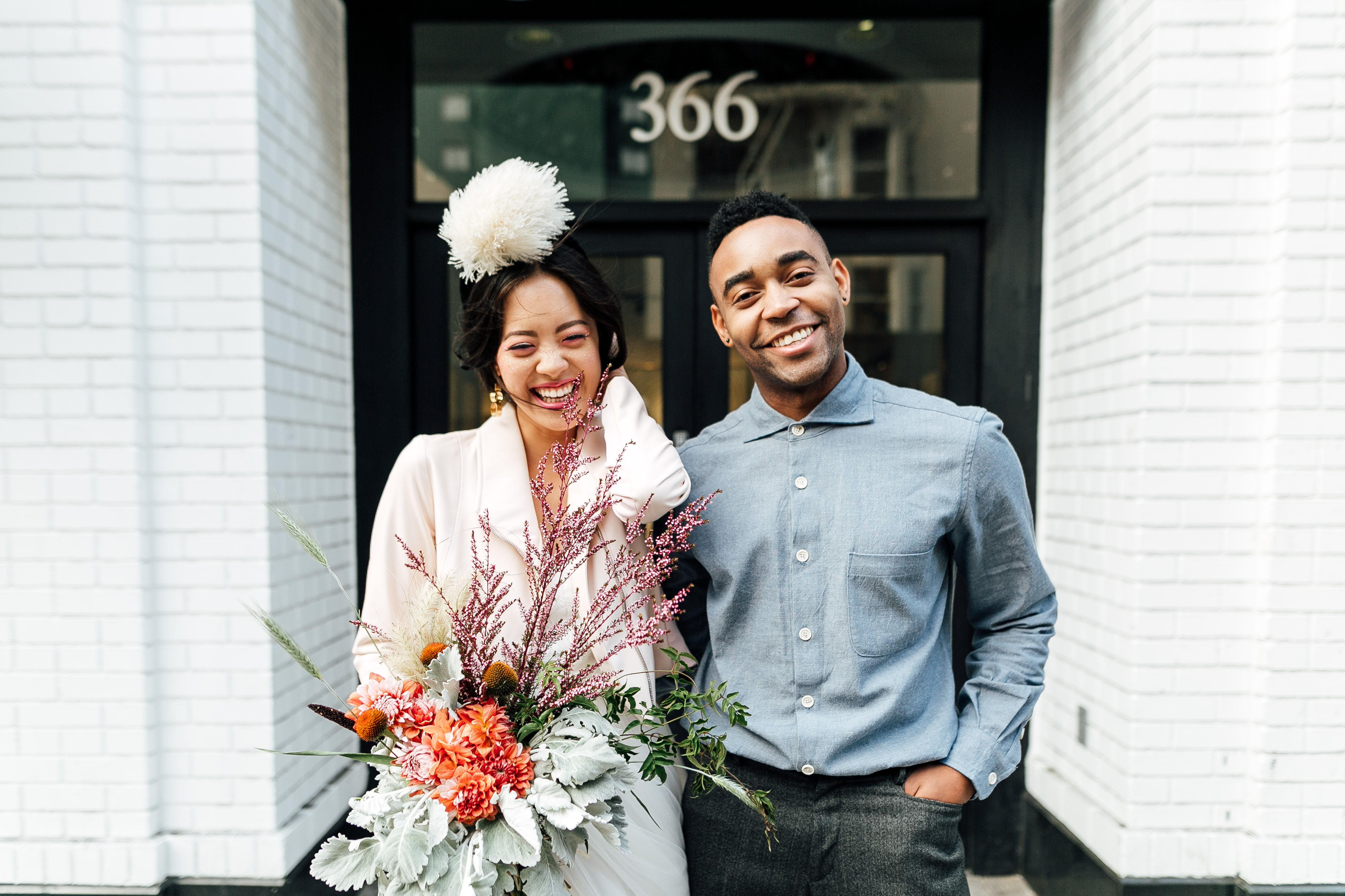 Ethically styled couple smiles, standing outside